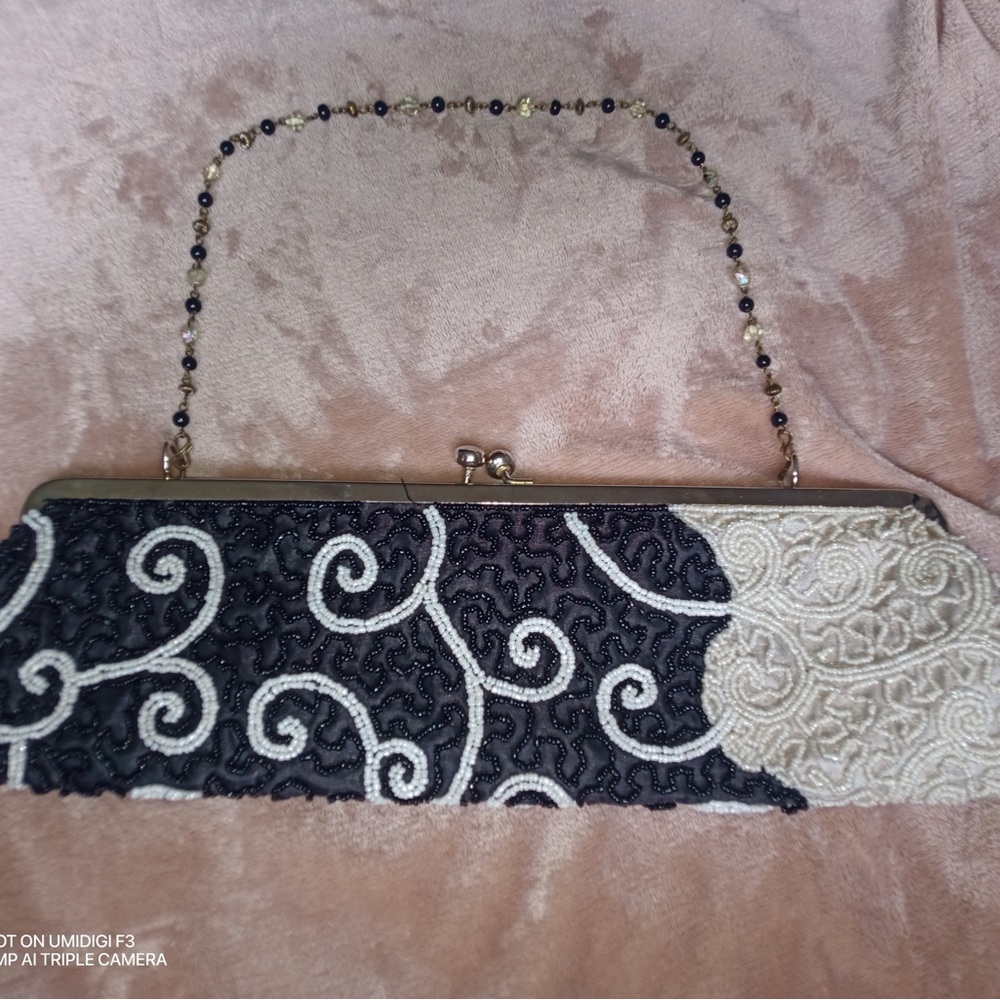 Katherine's Collection Black and Cream Clutch with Elegant Swirl Design